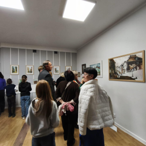 Na zdjęciu uczestnicy wewrnisażu podziwijący prace 