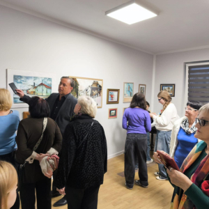 Na zdjęciu uczestnicy wewrnisażu podziwijący prace 